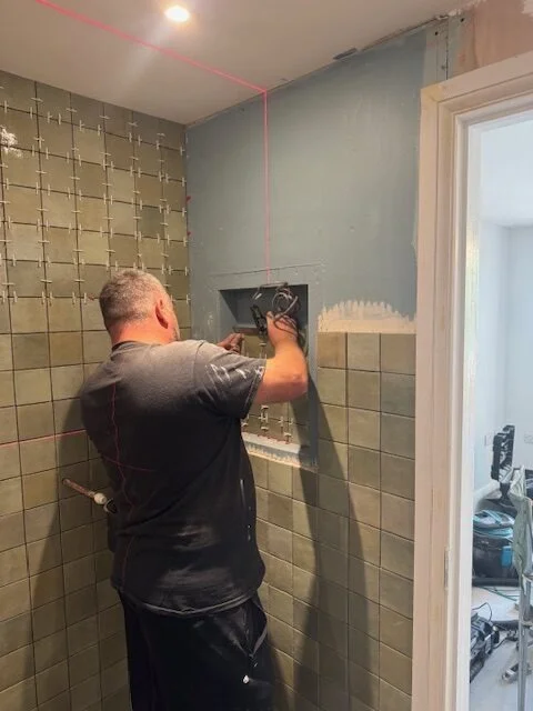 Rogate Construction Limited - Tiling a recess in a wet room in Liss